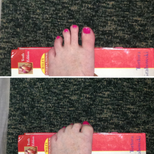 Demonstration of toe curl exercise - squeeze toes over the top of a big book.